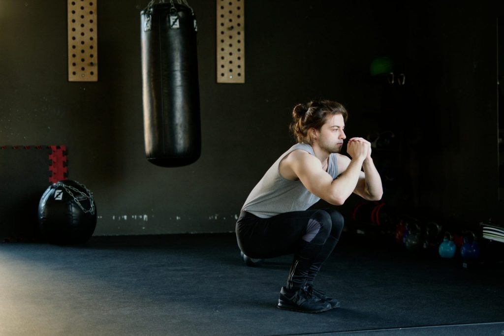 why do legs hurt after 40 - middle-aged woman doing squats for stronger legs