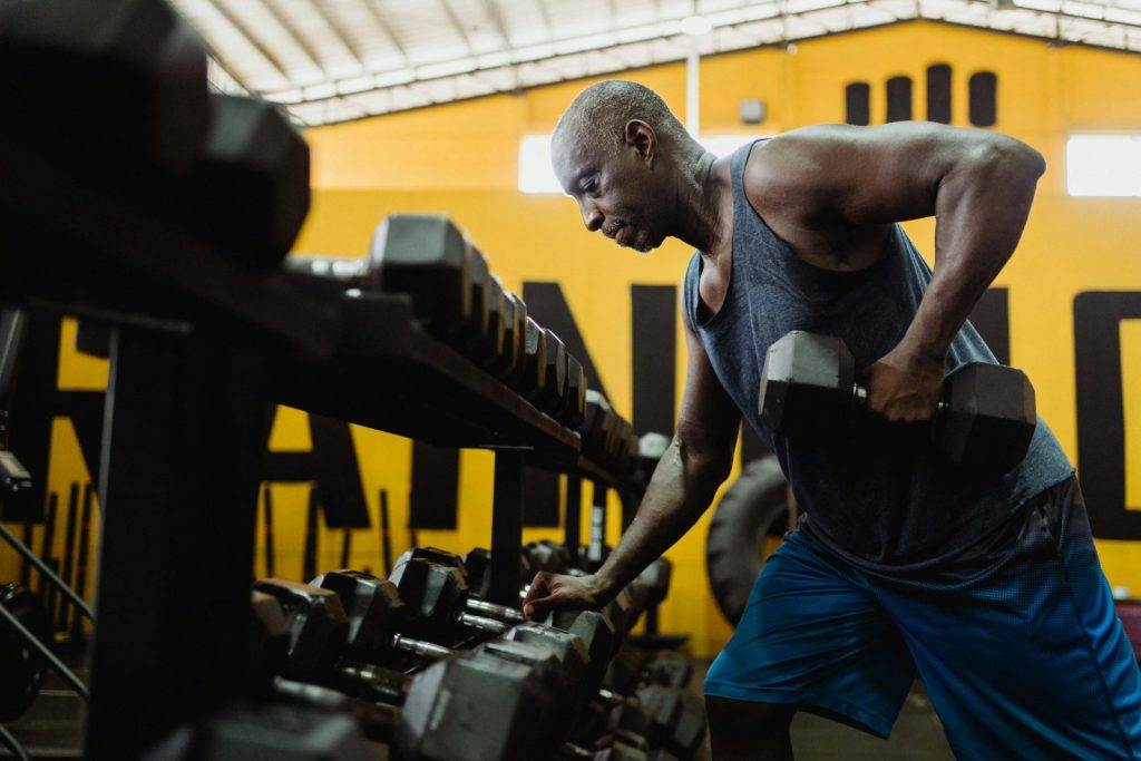 Middle-aged man lifting a dumbbell at the gym