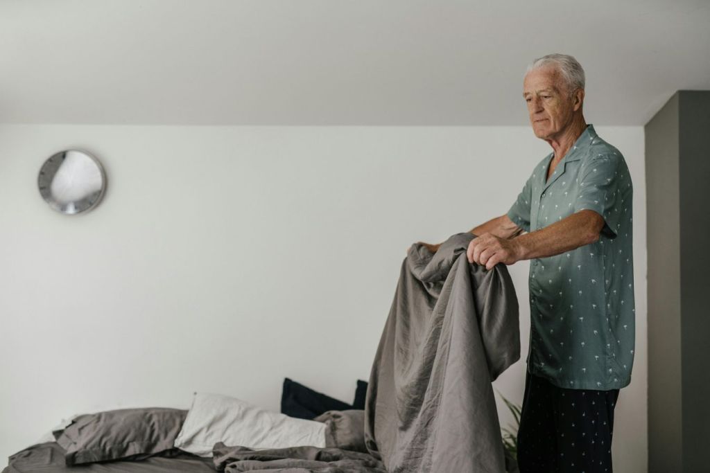 how to improve memory after 40 with better sleep habits, older man making bed