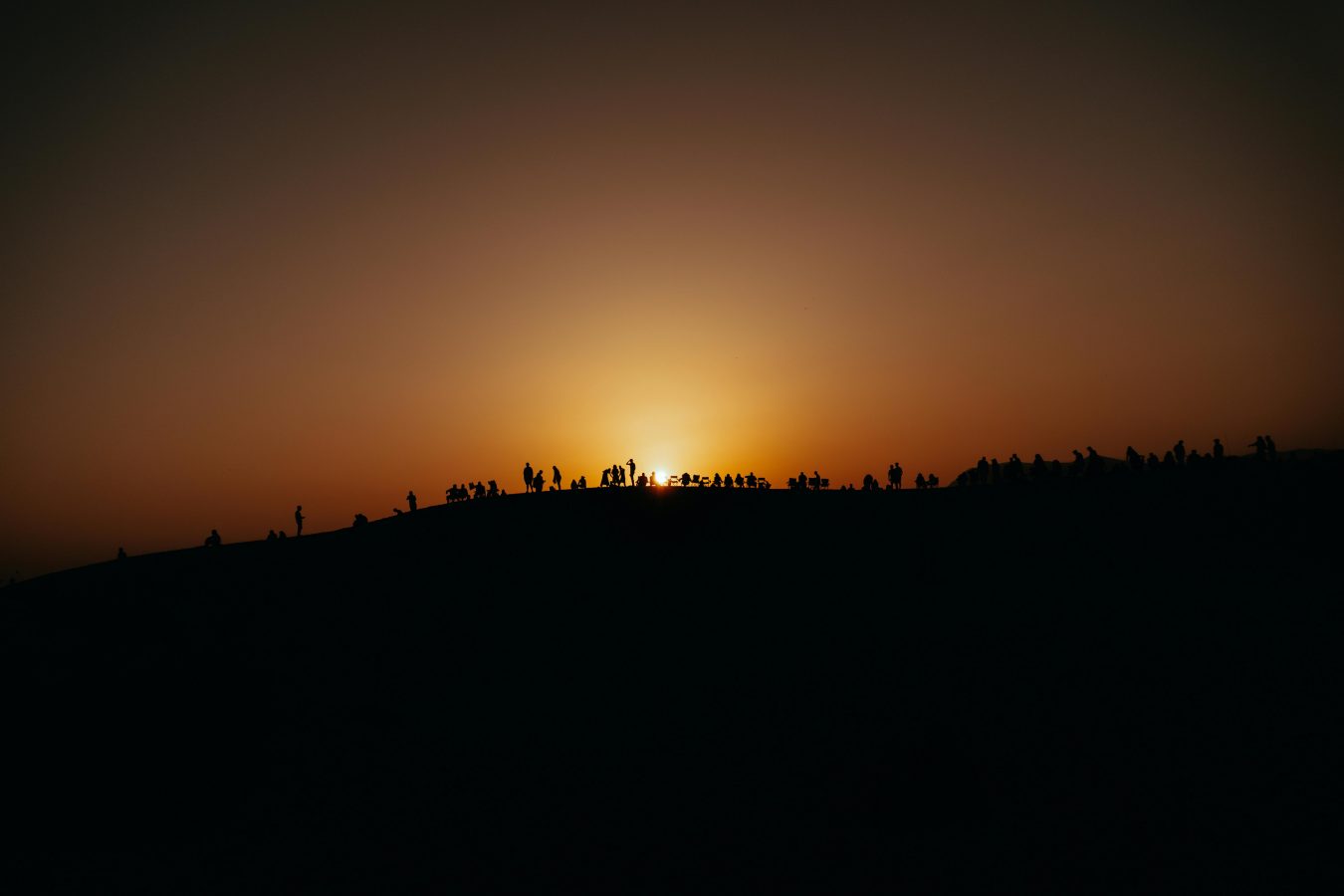 People watching sunset on ridge