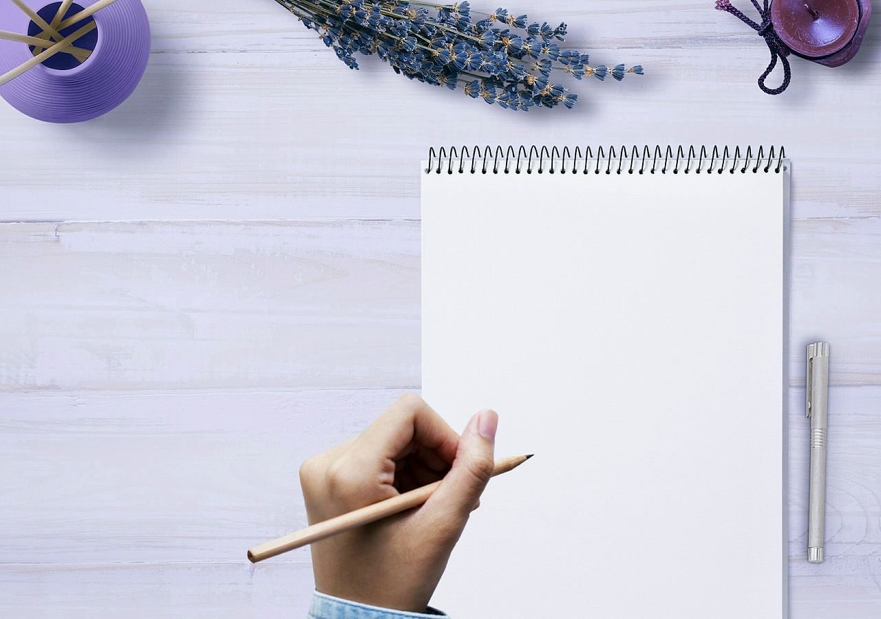 open diary with hand starting a new chapter