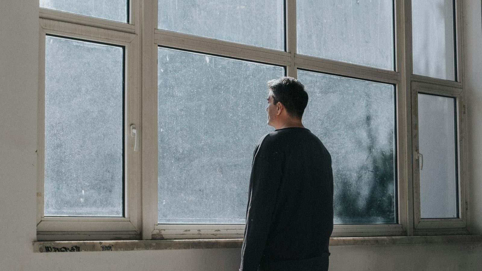 Man reflecting by the window